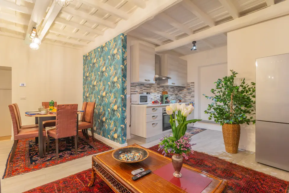 Soggiorno con travi a vista, cucina sullo sfondo – Bella Galiana